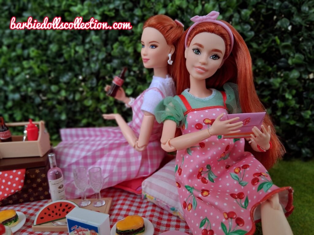 Close-up of a redhead Barbie opening an envelope at a Barbiecore picnic.