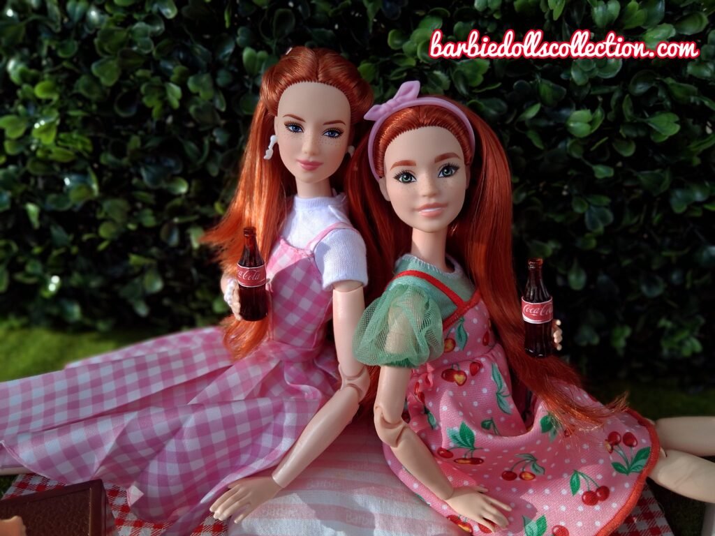 Two Barbie sisters sitting back-to-back holding sodas.