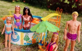 Malibu Barbie, Ken, Skipper, PJ, and Christie posing together by the swimming pool and looking at the camera during a vintage summer Barbie pool party diorama.