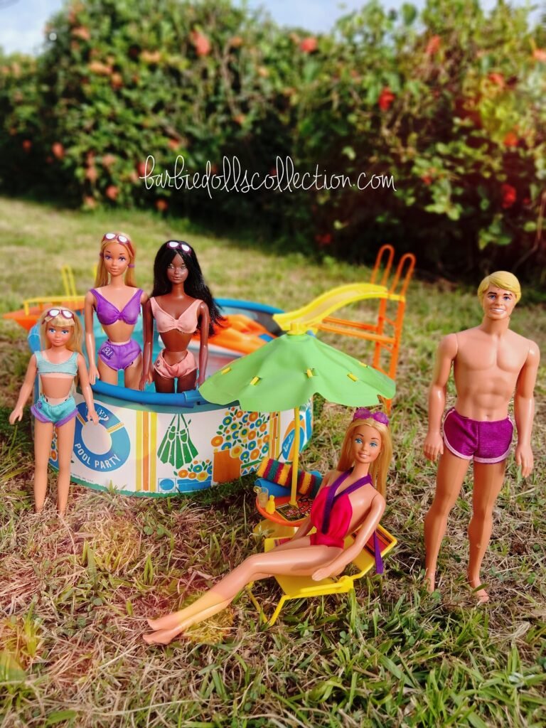 Malibu Barbie, Ken, Skipper, PJ, and Christie posing together by the swimming pool and looking at the camera during a vintage summer Barbie pool party diorama.