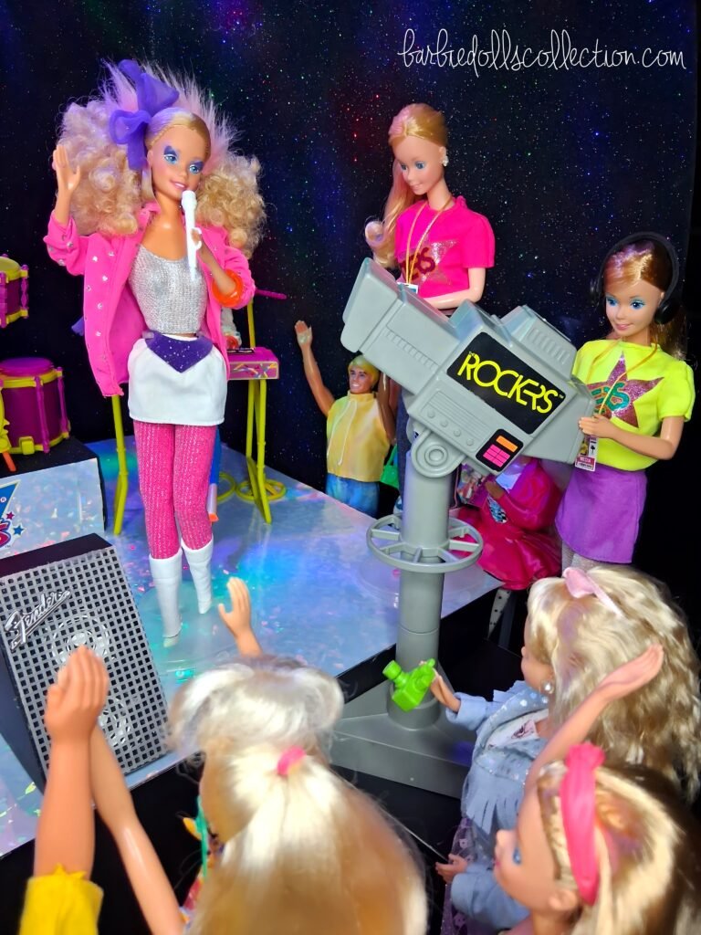 Barbie performing on stage while a TV camera focuses on her