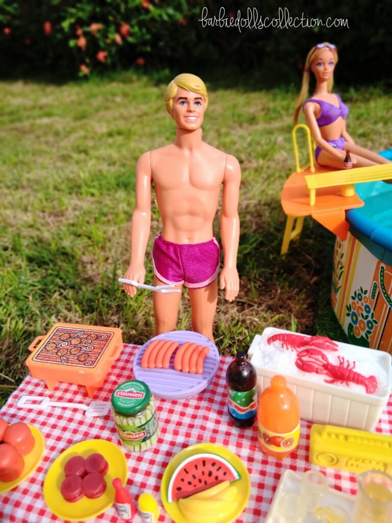 Ken grilling burgers and hot dogs at a backyard barbecue during a Barbie pool party, with a table full of summer food and refreshments nearby.