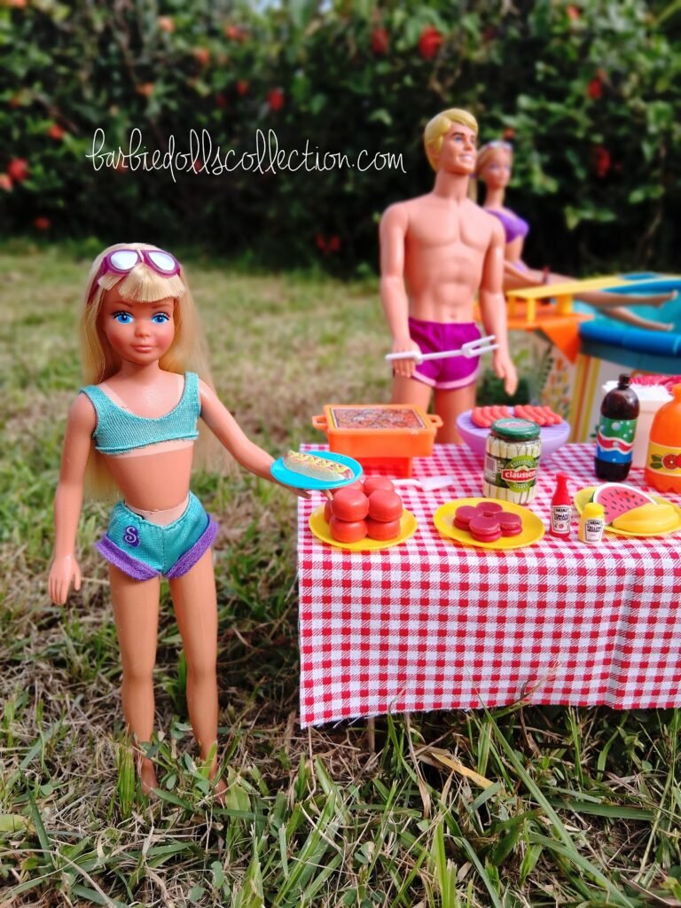 Skipper enjoying the Barbie summer pool party in the foreground, holding a plate with a hot dog while standing near the food table.
