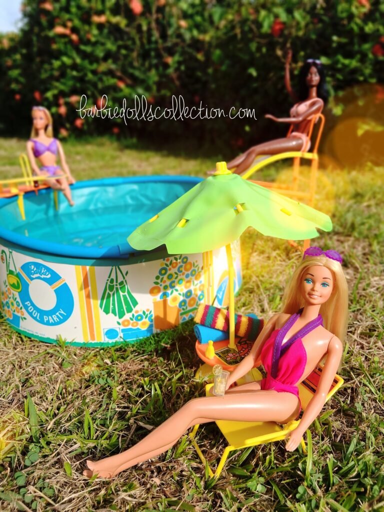 Vintage Malibu Barbie Summer Pool Party diorama featuring Malibu Barbie relaxing under a patio umbrella while Sun Lovin' Malibu PJ and Christie enjoy the backyard swimming pool.