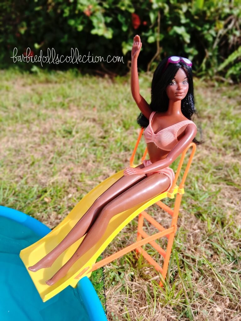 Vintage Malibu Christie enjoying a summer pool day as she slides down the backyard waterslide in the Barbie pool party diorama.