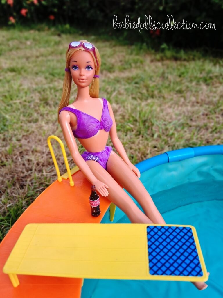Vintage Malibu PJ sitting at the edge of the backyard swimming pool while enjoying a bottle of soda during the summer Barbie pool party diorama.