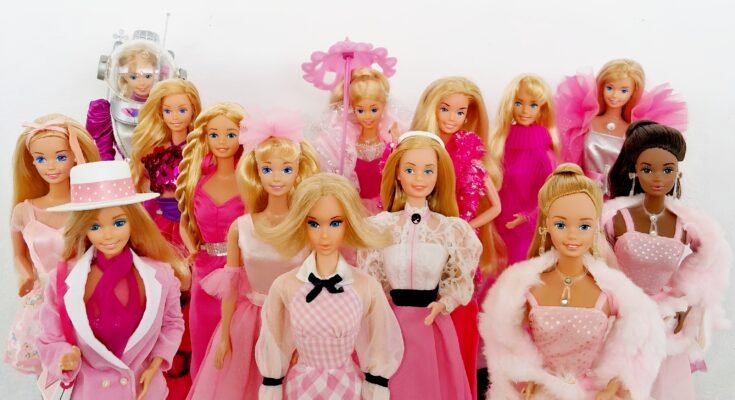 15 Barbie dolls dressed in pink for Breast Cancer Awareness Month
